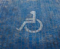 Top view on parking sign for disable people. Disabled parking space and wheelchair symbols on pavement Royalty Free Stock Photo