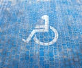 Top view on parking sign for disable people. Disabled parking space and wheelchair symbols on pavement Royalty Free Stock Photo