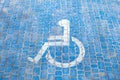 Top view on parking sign for disable people. Disabled parking space and wheelchair symbols on pavement Royalty Free Stock Photo