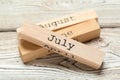 Top view of parts of wooden calendar on dark wooden tabletop