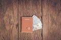 Top view passport with money on wood background Royalty Free Stock Photo