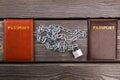 Top view passports and chains with padlock.