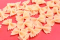 Top view of pasta with bows on red background Royalty Free Stock Photo