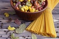 Top view on pasta of different colors, spaghetti are on the table, on a dark background