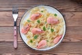 Top view of pasta fettuccine with shrimp in rustic plate with fork on wooden background Royalty Free Stock Photo