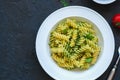 Top view of pasta pesto sauce served in a white plate on a black Royalty Free Stock Photo