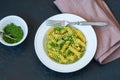 Top view of pasta pesto sauce served in a white plate on a black Royalty Free Stock Photo