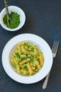 Top view of pasta pesto sauce served in a white plate on a black Royalty Free Stock Photo