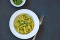 Top view of pasta pesto sauce served in a white plate on a black Royalty Free Stock Photo