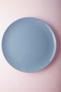 Top view of a pastel blue plate on a pastel peach background. Minimalism food photography. Geometric style. Royalty Free Stock Photo