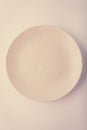 Top view of a pastel plate on a pastel peach background. Minimalism food photography. Geometric style. Royalty Free Stock Photo