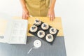 Top view of a pastry chef in a white kitchen in a beige apron getting ready before packing sweets Royalty Free Stock Photo
