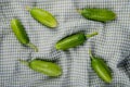 top view of pattern of cucumbers on plaid cloth background