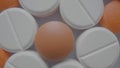 Top view of pattern from medical tablets and pills. White and brown round assorted medicines close up. Pharmaceutical or