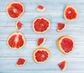 top view of pattern of sliced grapefruits on wooden background