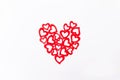 Top view patterned big shape of a heart made of wooden cutting red hearts on the white background. Valentine`s day, love Royalty Free Stock Photo