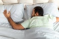 Top view of peaceful black man sleeping in comfy bed Royalty Free Stock Photo