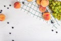 Top view of peaches, grapes and blueberries on the table. Summer vitamins. Copy space for text Royalty Free Stock Photo