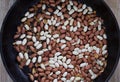 Top view of peanut with seed coat frying on the pan