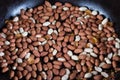 Top view of peanut with seed coat frying on the pan