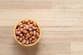 Top view of peanuts in a bowl on wooden background, Healthy eating concept Royalty Free Stock Photo