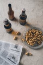 top view of peanuts newspapers and bottles of beer arranged Royalty Free Stock Photo