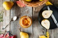 Top view Pear jam and fresh yellow ripe pears on old rustic wooden table. Autumn harvest still life concept. Selective focus. Flat