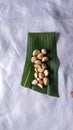 Top view peeled garlic and onion on banana leaf isolated white