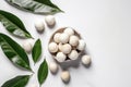 Top view of peeled macadamia nuts in a small plate next to the leaves on a white background. Generative AI