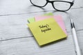 Top view of pen and colorful memo pad written with Today's Agenda on wooden background with copy space Royalty Free Stock Photo