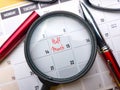 Top view pen and magnifying glass with a calendar marked 15 days Royalty Free Stock Photo