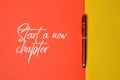 Top view of pen with text START A NEW CHAPTER Royalty Free Stock Photo