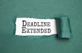 Top view of pen and torn paper written with DEADLINE EXTENDED Royalty Free Stock Photo