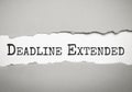 Top view of pen and torn paper written with DEADLINE EXTENDED Royalty Free Stock Photo