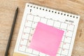 Top view of pencil, calendar planning and deadline with sticky note on wooden background, Calendar desk 2022 on January month