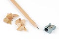 Top view of pencil and sharpener with shavings on white Royalty Free Stock Photo