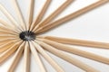 Top view of pencils made of wood lie on a white surface forming an open circle