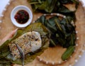 People eating flat rice dumpling on tray food background, special cake of Hue, delicious vegan rice flour dish Royalty Free Stock Photo