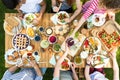 Top view on people eating pizza, pastry and salad during grill p Royalty Free Stock Photo