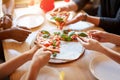 Top view of people hand and eating delicious pizza at restaurant, close up Royalty Free Stock Photo