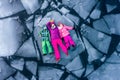 Top view of people lying on ice alone. Woman and children in bright clothes on broken ice block in water. Winter cracked