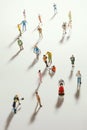 Top view of people miniature toys with long shadows keep distance away in public during sunrise or sunset.Social distancing / Royalty Free Stock Photo