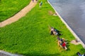 Top view, people are resting on wooden chairs on the lawn by the river