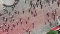 Top view of people running on street of city center smeared colorful holi paints at Color Run Kyiv f