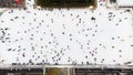 Top view of people skating on open air ice rink on winter day New Year Christmas