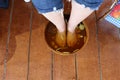 Top view of people soaking their legs in herbal water for foot spa treatment for healthy feet.