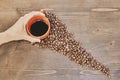 Top view of a person holding a cup of coffee with roasted coffee beans on the table Royalty Free Stock Photo
