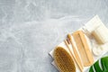 Top view personal hygiene products and bath SPA accessories on stone background. Flat lay bath brush, wooden hair comb, bamboo