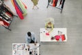 Top view perspective of dressmaker and fashion design studio with dressmaker and trailor working