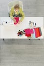 Top view perspective of dressmaker and fashion design studio with dressmaker and trailor working